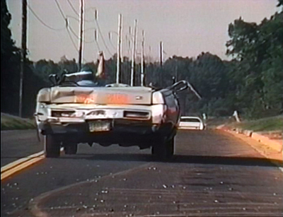 This guy sheared off the roof under a semi, leapt from the car to avoid the jolt when the truck hit it again, then got in and gave chase. Georgia cops are tough, man.